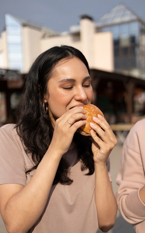 Woman enjoying some street food outdoors